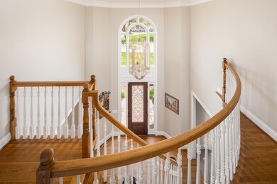 Upon entering, you are greeted by the freshly painted two story foyer, new front door with beveled glass, gleaming refinished hard wood floors, extensive molding that extends throughout, and the beautiful staircase. 