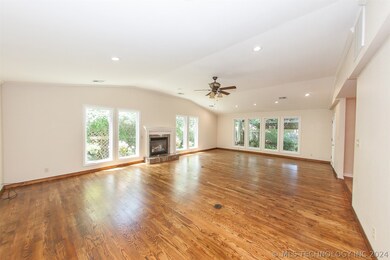 Great Room Fireplace with windows overlooking pati
