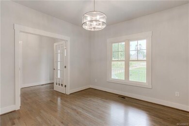 Dining Room w/Chandelier & Wood Laminate Floors