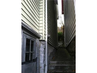 Exterior Front. Side entrance into basement