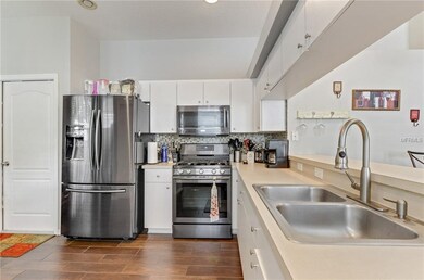 Stainless Appliances and mosaic tile backsplash