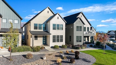 View of front facade featuring a front yard, a residential view, and board and batten siding