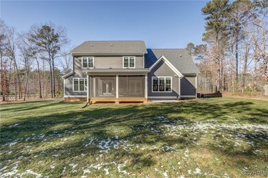 Back of house viewing yard, screened porch and pat