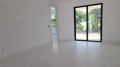 Spare room featuring baseboards and light marble f