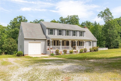 View of front of home with driveway, covered porch