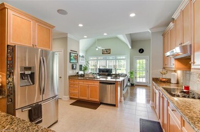 Large kitchen with granite counter tops and stainless steel appliances.
