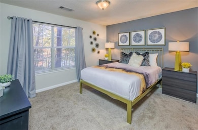 Carpeted bedroom with a textured ceiling