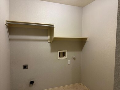 Laundry area featuring hookup for an electric dryer, hookup for a washing machine, gas dryer hookup, and light tile patterned flooring