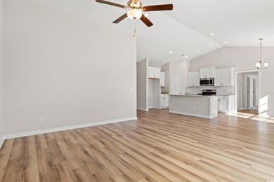 Unfurnished living room with ceiling fan with nota