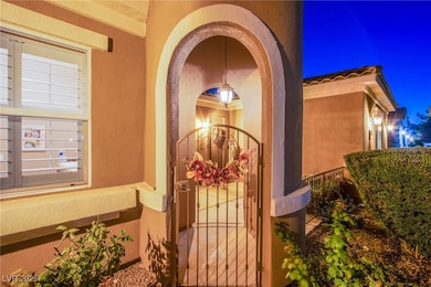 Property entrance featuring a gate and stucco siding