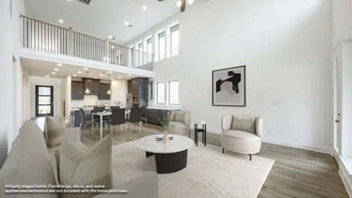 Living area featuring a towering ceiling, light w