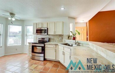 Kitchen featuring appliances with stainless steel finishes, light countertops, backsplash, a textured ceiling, and light tile patterned floors