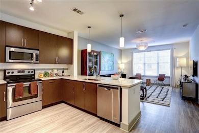Kitchen featuring appliances with stainless steel 