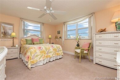 Large master bedroom with sitting area and windows