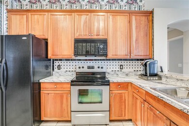 KITCHEN with WOOD CABINETS, TILED BACKSPLASH, qual