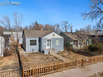 View of front of home featuring a fenced front yard, roof with shingles, and a chimney
