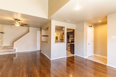 Unfurnished living room with light wood-style flooring, stairway, ceiling fan, washer / dryer, and recessed lighting