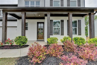 Property entrance with a porch and brick siding