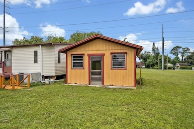 Utility shed adjacent to mobile home, used for laundry