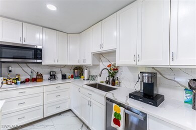 Kitchen featuring stainless steel appliances, a si