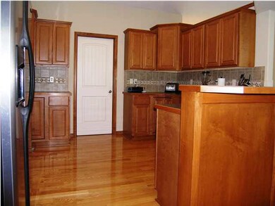 An overview of the maple cabinetry kitchen.