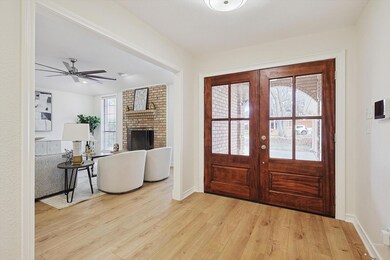 Foyer with light wood-type flooring and new, wood 