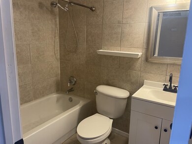 Full bathroom featuring tile walls, decorative bac