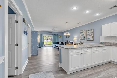 Kitchen with white cabinetry, light hardwood / woo