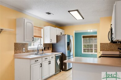 Large tile flooring, abundant white cabinetry, and