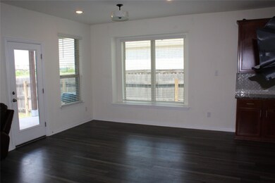 Unfurnished dining area with dark wood-style floo