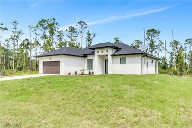 Prairie-style house with a garage, driveway, a fro