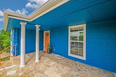 View of exterior entry with covered porch