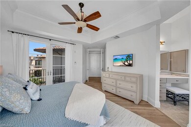 Bedroom featuring access to outside, a tray ceilin