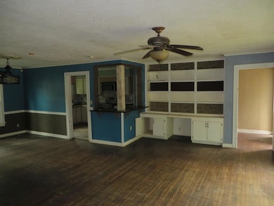 Unfurnished living room featuring ornamental moldi