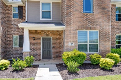 View of exterior entry featuring brick siding
