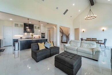 Tiled living room with high vaulted ceiling, beam 
