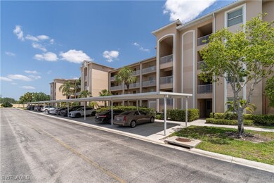 View of building exterior featuring covered parkin