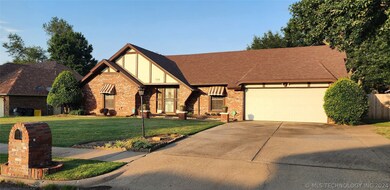 Front showing brick mailbox and large driveway