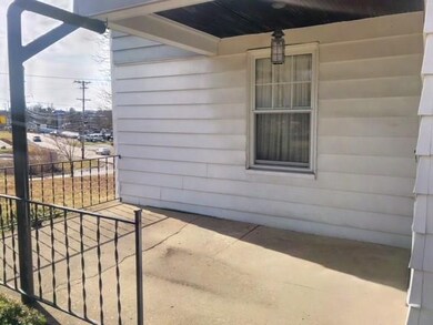 Covered back porch overlooks the backyard.