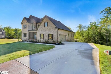 With stamped and stained concrete accent on drivew
