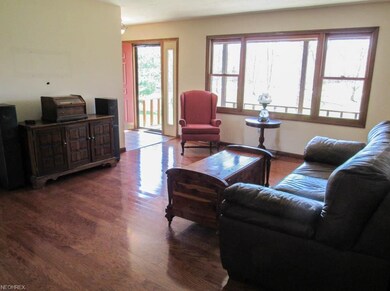 Living room with a picture window and hardwood flo