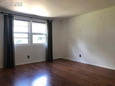 Unfurnished room with dark wood-style flooring and