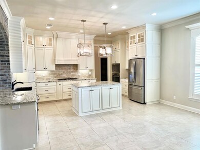 Kitchen with tasteful backsplash, a kitchen island
