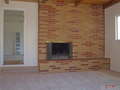 fireplace in bedroom 3 with open beam ceilings
