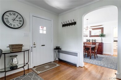 Front door leads into spacious, welcoming living room. Large archway leads to formal dining room and onto kitchen. 
 Smaller archway leads to back hall that connects to first floor en-suite bedroom, utility room and family room.