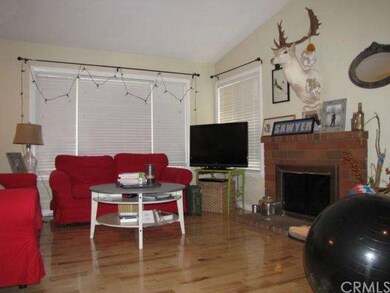 Entry leads into living room with hardwood floors 
