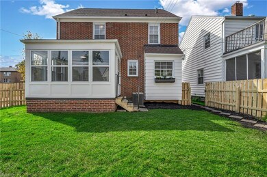 Back of house with central AC, enclosed porch, & f
