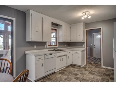 White, enameled cabinetry with nickel hardware & w