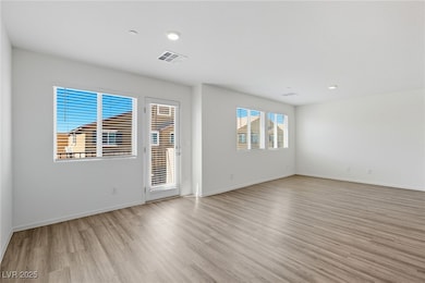 Empty room featuring light wood finished floors and recessed lighting