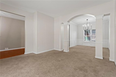 Unfurnished room with arched walkways, decorative 